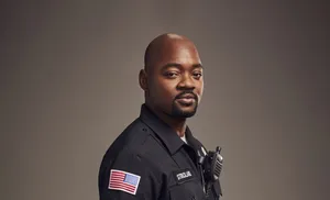 Charming Black Man Showcasing Confident Elegance Wallpaper