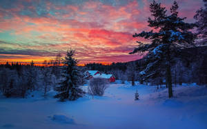 Charming Winter Homestead In Snowy Landscape Wallpaper