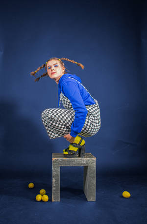 Checkered Jumpsuit Girl On Chair Wallpaper
