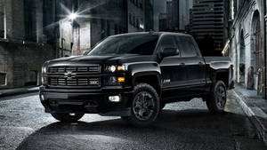 Chevrolet Silverado 1500 - A Black Truck Parked In A City Wallpaper