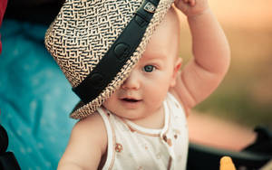 Child With Blue Eyes And Hat Wallpaper