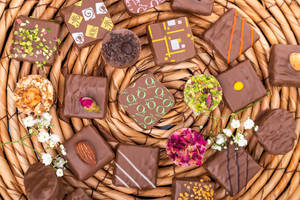 Chocolates With Assorted Flowers Wallpaper
