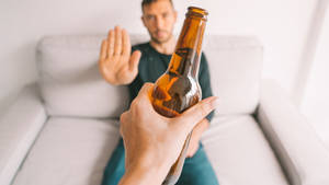 Choosing Sobriety - Man Rejecting Alcohol Wallpaper