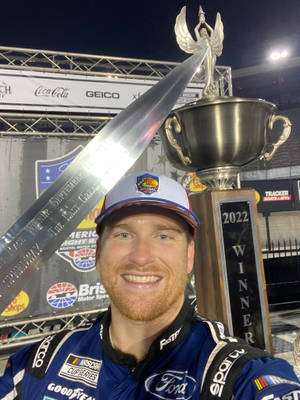 Chris Buescher Holding Championship Trophy Wallpaper