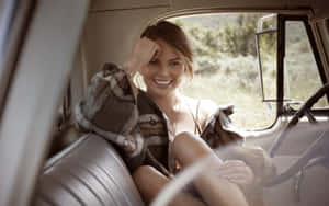 Chrissy Teigen Smiling In Car Wallpaper