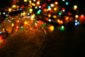 Christmas Ball Against Festive Lights Bokeh Shot Wallpaper