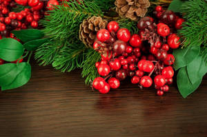 Christmas Wreath With Cluster Of Cherries Wallpaper