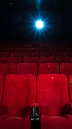 Cinema Hall Empty Seats Under Spotlight Wallpaper