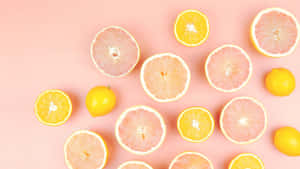 Citrus Fruit Assortment Pink Background Wallpaper
