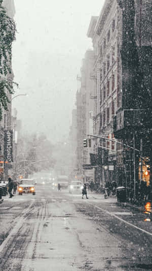 City Street With Snow Falling Wallpaper