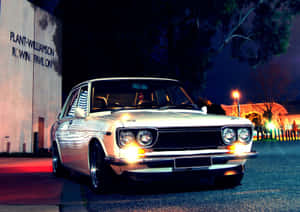 Classic Datsun 1600 Cruising On The Open Road Wallpaper