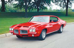 Classic Red Pontiac Gto Muscle Car On A City Street Wallpaper