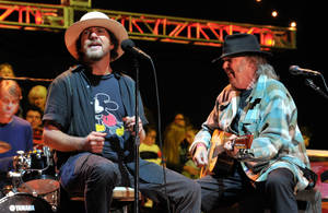 Classic Rock Icons - Eddie Vedder And Neil Young Performing With Pearl Jam Wallpaper