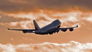 “climb Aboard A Classic: A Boeing 747 Airliner In Flight” Wallpaper
