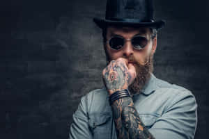 Close-up Of A Bearded Man Showcasing Intricate Hand Tattoo Wallpaper