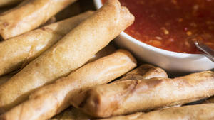 Close-up Of Egg Rolls With Dip Wallpaper