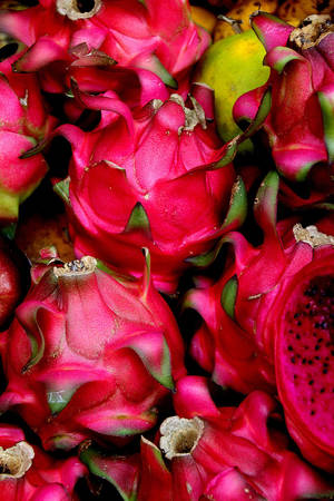 Close-up View Of Vibrant Dragonfruit Bunch Wallpaper