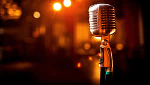 Closeup View Of A Carbon Microphone Illuminated By Glaring Lights Wallpaper