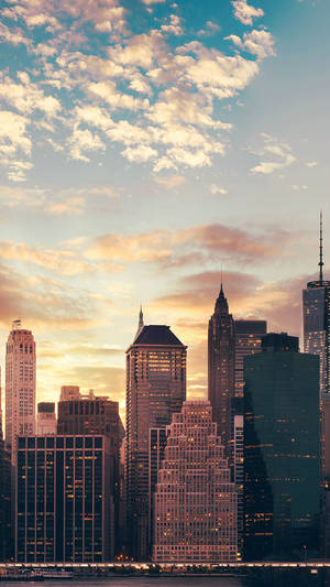 Cloudy Sunset Over New York Skyline Iphone Wallpaper