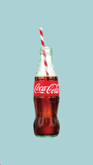 Coca Cola Bottle With A Straw On A Blue Background Wallpaper