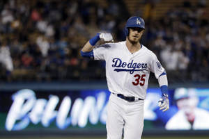 Cody Bellinger Flexing In Field Wallpaper