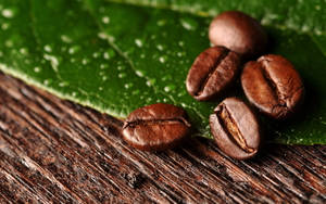 Coffee Beans On Leaf Wallpaper