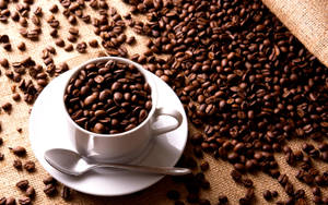 Coffee Cup Filled With Coffee Beans Wallpaper