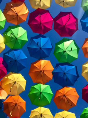 Colorful Floating Umbrellas Wallpaper
