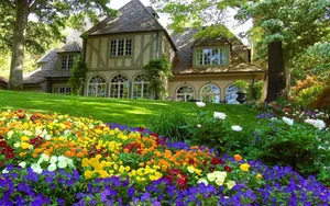 Colorful Flowers Near A Farmhouse Desktop Wallpaper