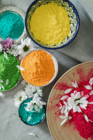 Colorful Holi Celebration With Hd Flowers And Powders Wallpaper