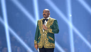 Comedian Steve Harvey During His Charismatic Performance On Stage. Wallpaper
