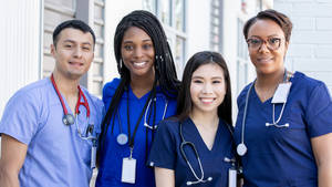 Compassionate Healthcare Team In Action Wallpaper