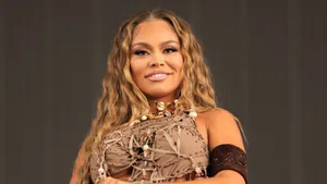 Confident Performer Smiling Wallpaper