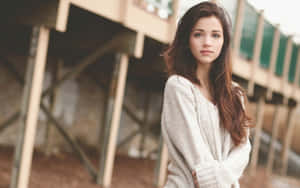 Confident Teenage Girl In Comfortable Sweater Wallpaper