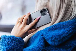 Confident Young Woman Making A Phone Call Wallpaper