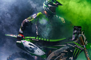 Conquer Tracks On The Monster Dirt Bike Wallpaper