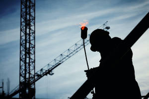 Construction Worker On Top Of A Building Wallpaper