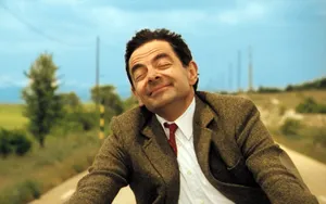 Contented Man Smiling Outdoors Wallpaper