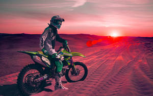 Cool Bike Rider On A Desert At Sunset Wallpaper