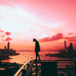 Cool Sad Boy Walking On Railings Wallpaper