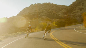 Country Road Downhill Cycling Wallpaper