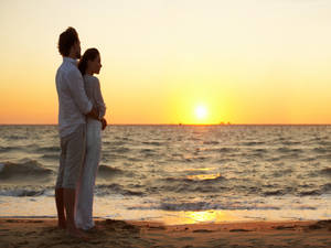 Couple At Beach Kerala Sunset Wallpaper