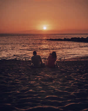 Couple At Beach Sunset Photograph Wallpaper