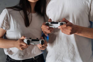 Couple Hands Gaming Controllers Wallpaper