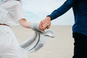 Couple Holding Hands Beach Walk Wallpaper