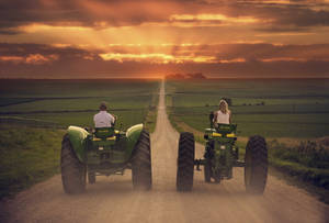Couple Riding John Deere Tractors Wallpaper