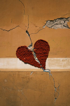 Cracked Heart On Brown Wall Wallpaper