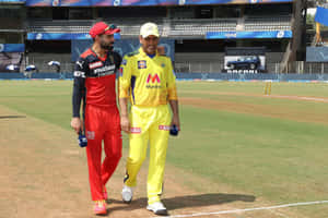 Cricket Captains Kohli Dhoni Walking On Field Wallpaper