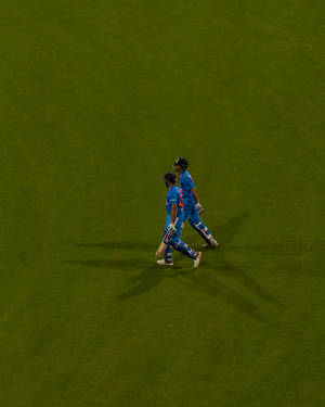 Cricket Teammates In Blue Wallpaper