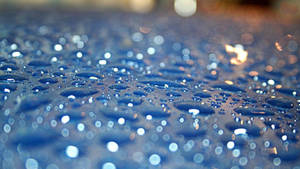 Crystal Like Raindrops On A Blue Surface Wallpaper